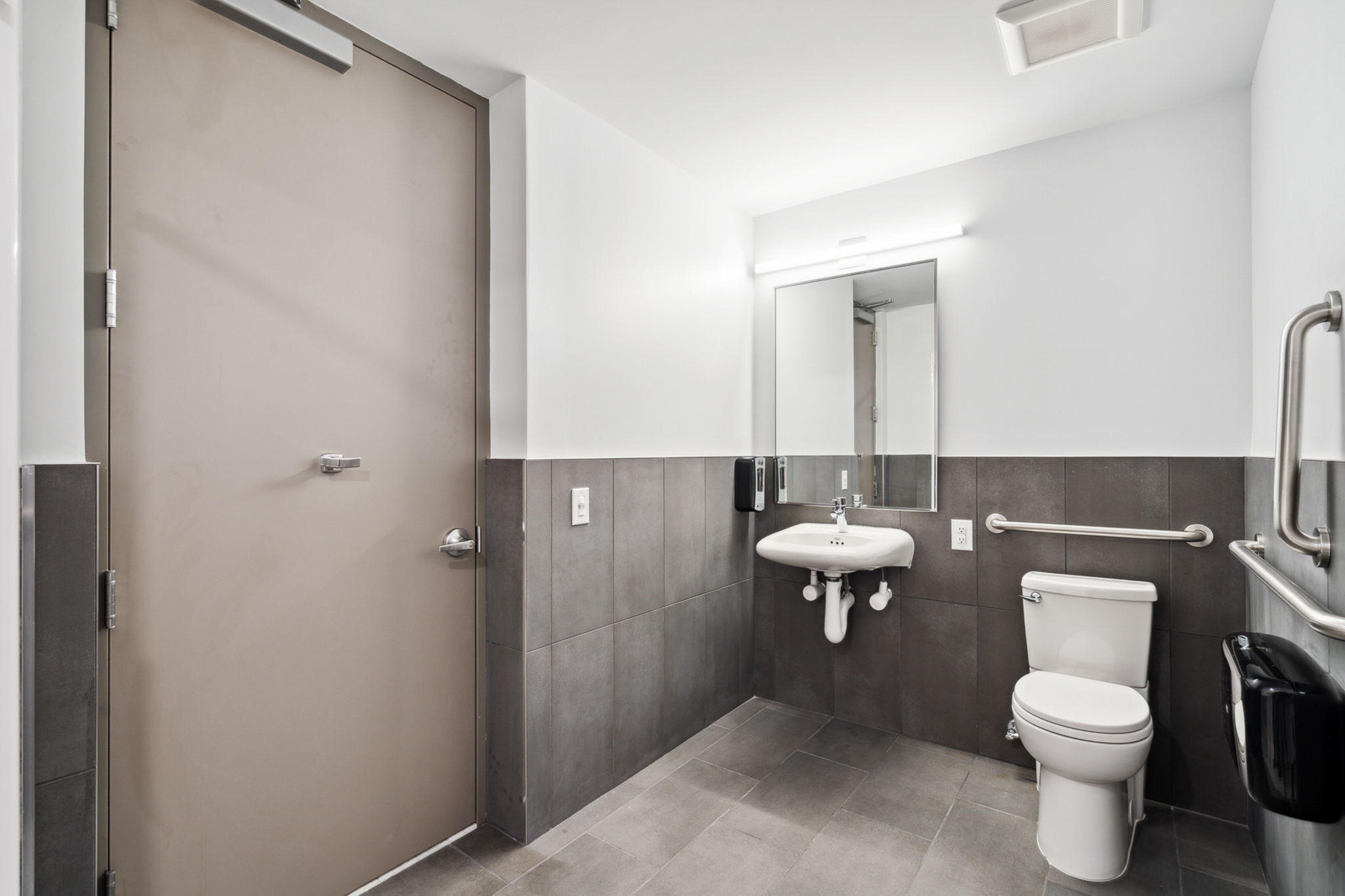 Accessible bathroom. Modern tile. Upgraded bathroom appliances. Upgraded lighting fixtures. 