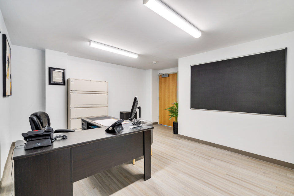 Metal filing cabinets. Filing space. Blackboard. Functional workspace. Office supply organization. 