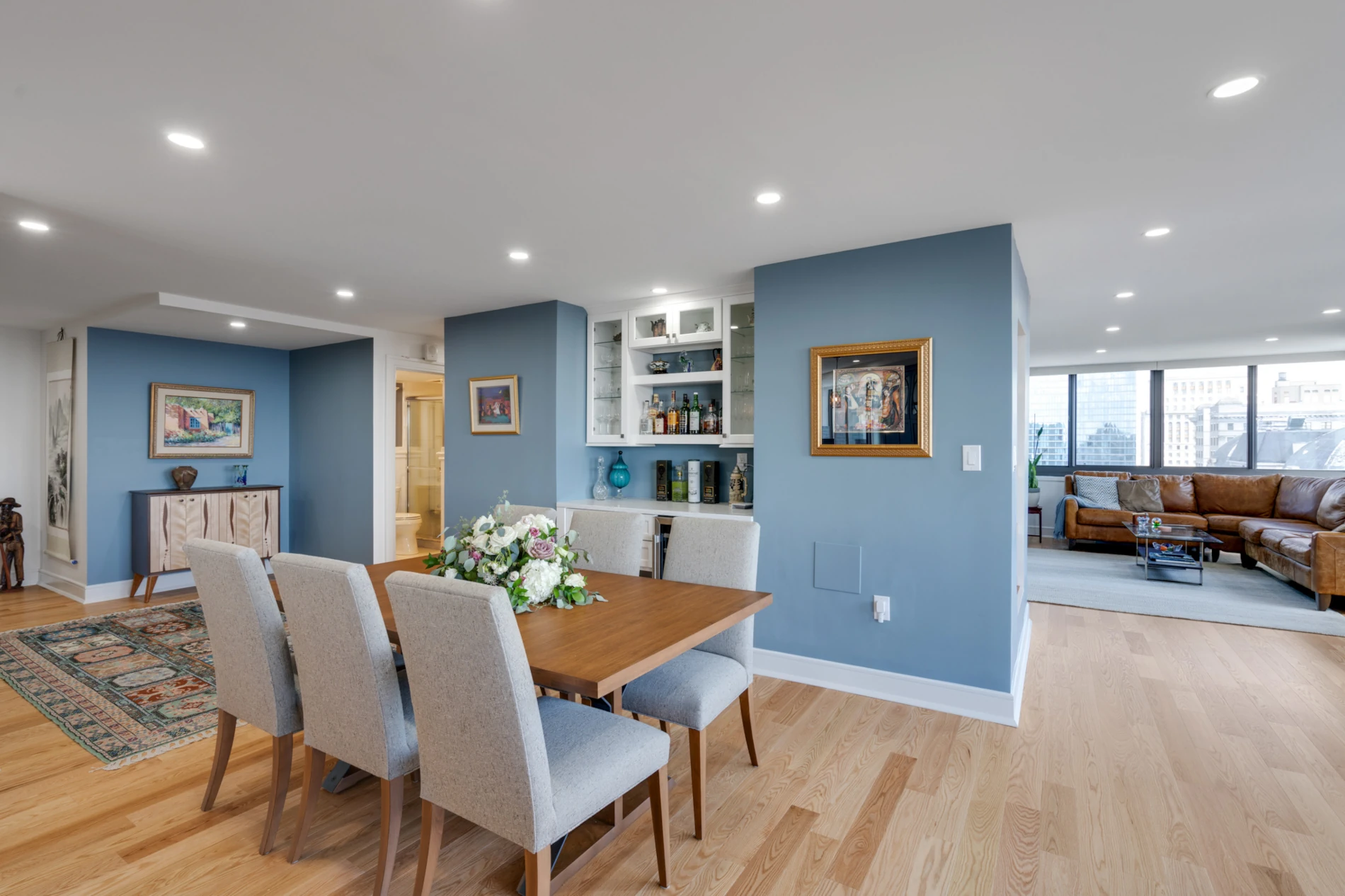Custom bar area. Glass shelving. Glass paned cabinets. Open concept dining.