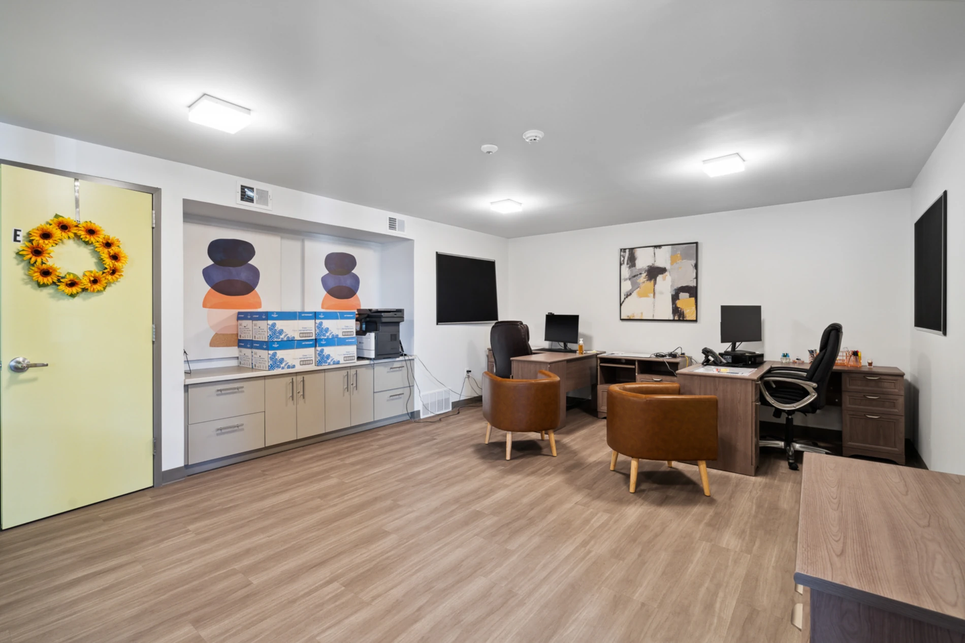 Large office. Custom built-in cabinets. Wood flooring. 