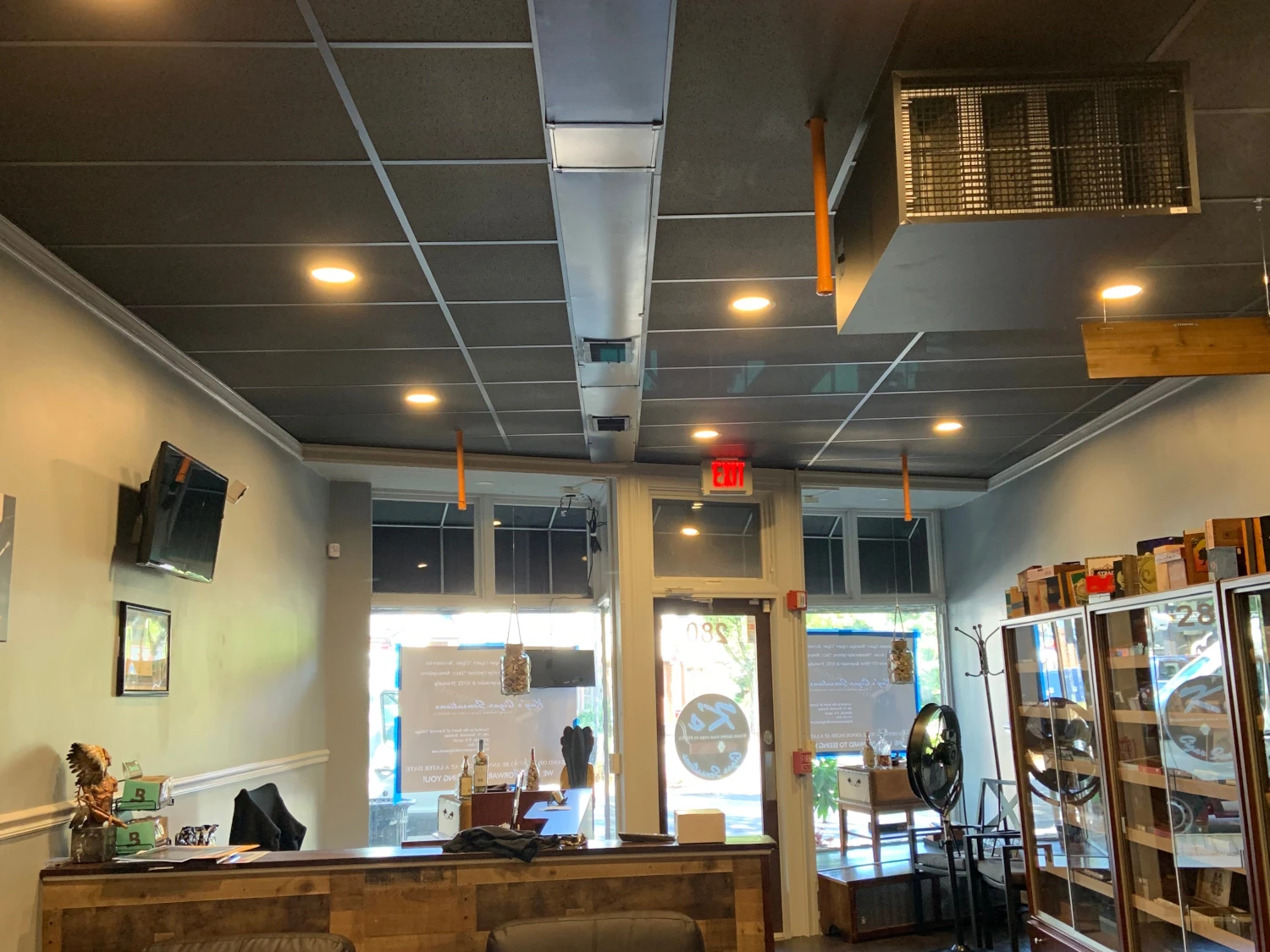 Retail entryway with stylish merchandise displays, and host area.  