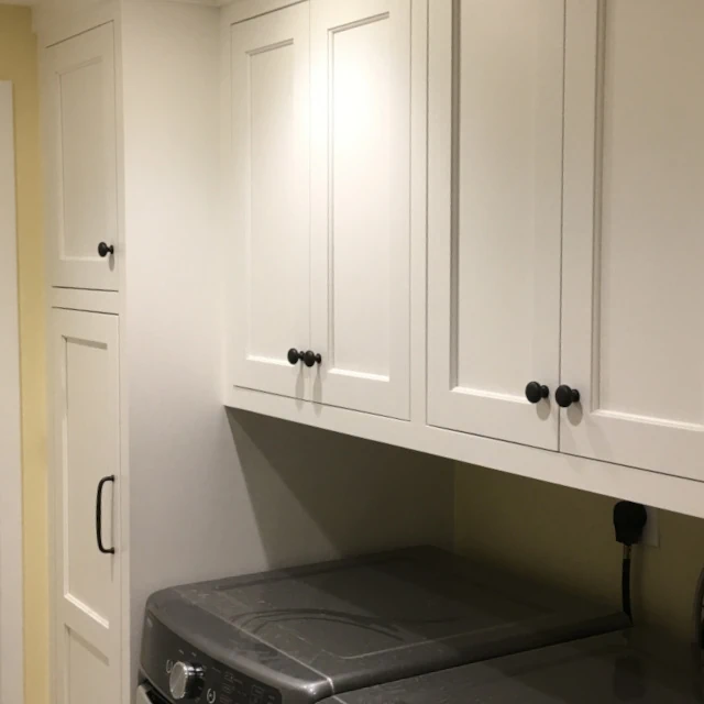 Custom cabinetry in Laundry room featuring stylish and functional storage.